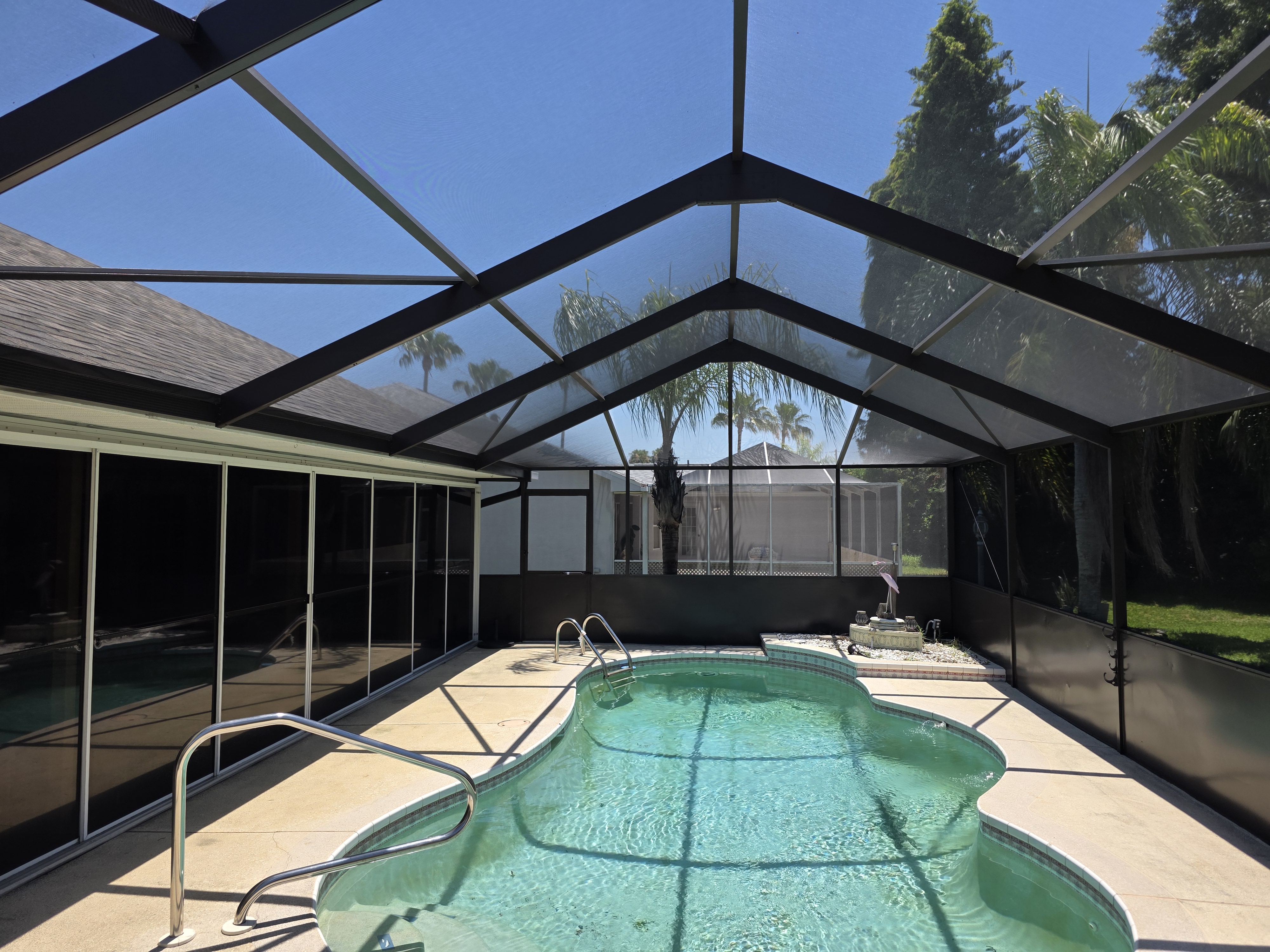 Screening Dunrite pool cage or lanai project photo — Why Your Pool Cage Screens Turn Gray and Brittle (And What to Do)